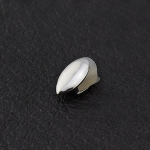 Polished silver single canine tooth grillz for hip hop style on black leather background