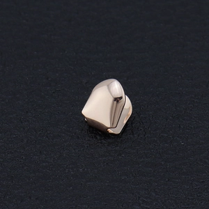 Hip hop single tooth grillz with polished rose gold plating and faceted metal surface