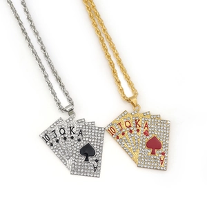 Close-up of hip hop poker royal flush pendants in gold and silver with white rhinestones