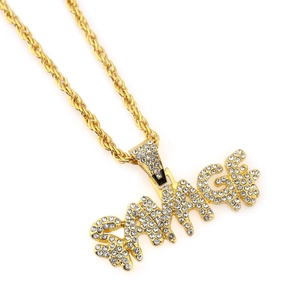 Macro shot of gold-plated rope chain and iced-out SAVAGE letter pendant for hip hop style