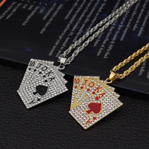 Macro view of iced-out gold and silver poker royal flush pendants on a black background