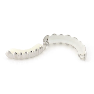 Macro view of silver hip-hop grillz set including top and bottom teeth with silicone bars