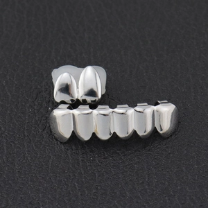Close-up of hiphop silver grillz set including 2-top and 6-bottom polished teeth grills