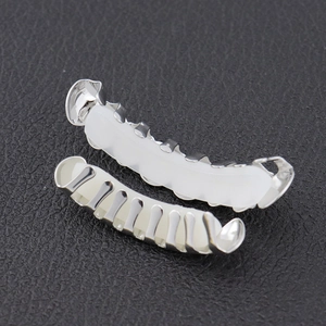 Silver hip hop grillz set with inner silicone fixing bars on black leather background