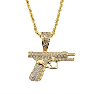 Gold-plated hip hop pistol pendant necklace with sparkling cubic zirconia on rope chain