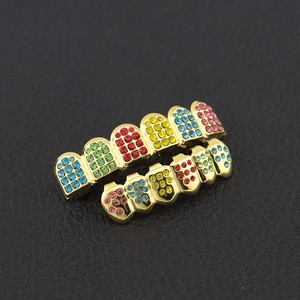 Detailed close-up of hip hop gold teeth grills with colorful micro-pave crystals