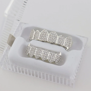 Macro shot of silver hip hop grillz set with pavé cubic zirconia in a white display box