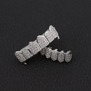 Macro shot of silver-plated hip hop grillz featuring iced-out zircon micro-pave setting