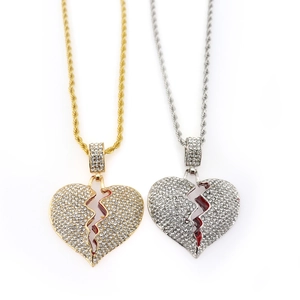 Detailed view of hip hop broken heart pendants with red enamel and pavé rhinestones