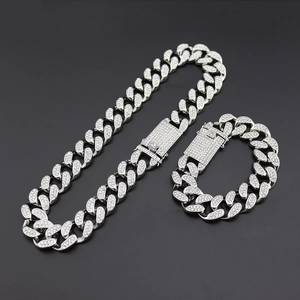 Macro shot of silver-plated iced out Cuban link chain set with sparkling rhinestones