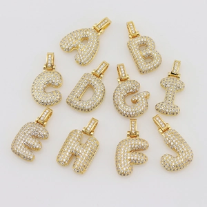 Macro shot of gold plated hip hop letters A-J with iced out cubic zirconia paving