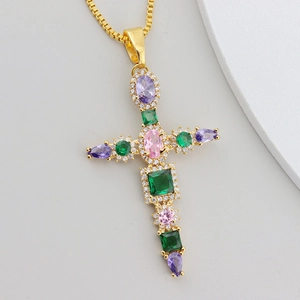Close-up of gold-plated cross pendant with vibrant multi-colored zirconia stones