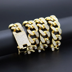 Close-up of 20mm iced out golden Cuban link chain with detailed crystal encrusted clasp