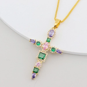 Close-up of gold-plated cross pendant with multicolored cubic zirconia on square chain