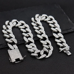 Macro shot of 20mm iced out silver Cuban link chain with dense diamond pavé detailing