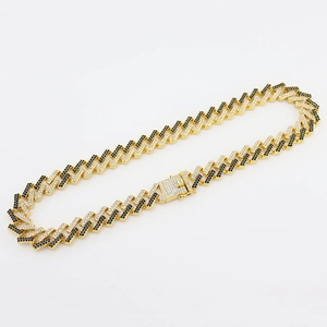 Close-up of 15mm gold Cuban link chain with black and white pavé stones and box clasp
