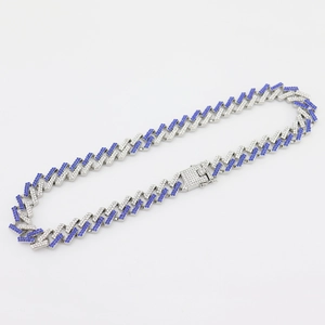 Macro detail of 15mm Cuban link necklace with blue and white pavé rhinestones