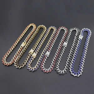 Detail view of 15mm Miami Cuban link chains in gold and silver with colorful diamonds