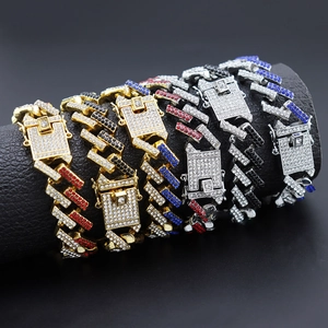 Detail of multi-color iced out Cuban link bracelets with vibrant rhinestones on black display
