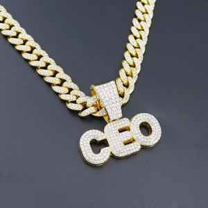 Close-up of hip-hop CEO pendant with iced-out rhinestones on a gold Cuban chain