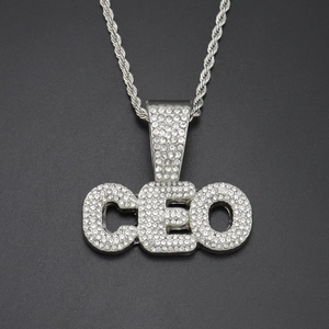 Macro shot of silver hip hop CEO pendant with sparkling micro-pave crystal set on rope chain