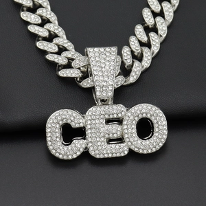 Close-up of iced-out CEO letter pendant with sparkling diamonds on silver Cuban chain
