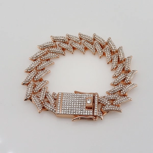 Macro detail of rose gold iced out Cuban link bracelet with sharp leaf-shaped diamond links
