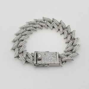 Close-up of iced out silver Cuban link chain with high-density diamonds and square clasp