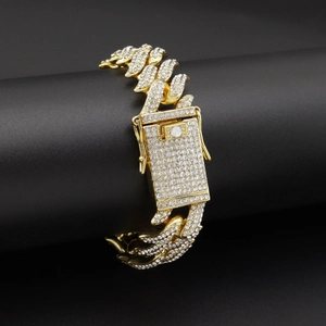 Detailed view of gold plated iced out Cuban chain with sparkling diamonds on a black stand