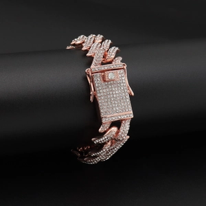 Macro shot of rose gold iced out Cuban link bracelet with sparkling rhinestones detail