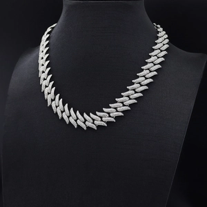 Detailed close-up of iced-out thorn Cuban link chain necklace on a black display bust