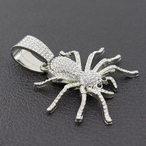 Iced out silver spider pendant necklace with white diamonds and black gemstone eyes