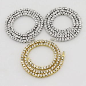 Detail view of silver and gold tennis chains with clear round-cut zircon stones