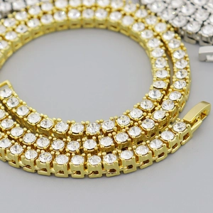 Close-up of gold and silver tennis chains showing fine prong setting and sparkling crystals