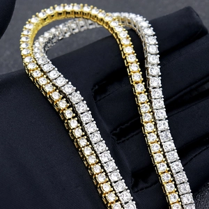 Close-up of gold and silver tennis chains with high-density white zircon on black silk
