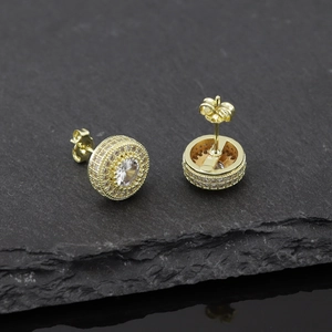 Macro detail of gold-plated hip hop earrings with micro-paved cubic zirconia stones