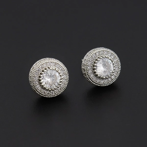 Close-up of hiphop button earrings with micro-paved ice crystals on a black background