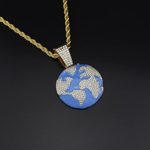 Close-up of hip hop earth pendant with blue enamel and crystal map on gold rope chain