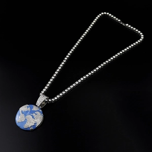 Macro shot of hip-hop earth pendant with blue enamel and sparkling crystal tennis chain