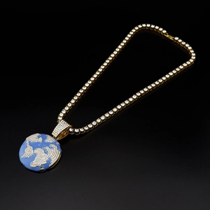 Detail of iced out hip-hop tennis chain with world map globe pendant in gold finish