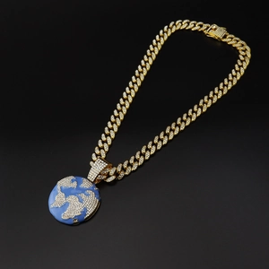 Detailed close-up of hip-hop globe pendant with blue enamel and iced-out cubic zirconia stones