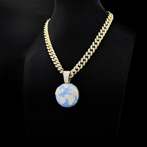 Hip hop style gold Cuban link chain with a world map globe pendant iced out with zircons