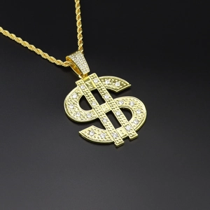 Macro shot of gold-plated hip hop dollar sign pendant with sparkling inlaid rhinestones