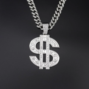 Close-up of iced out silver dollar sign pendant with sparkling rhinestones on cuban link chain