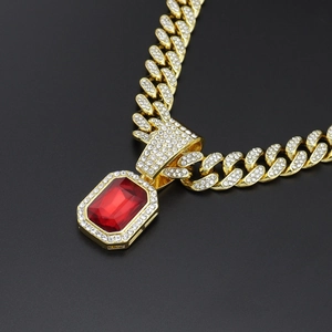 Hiphop style gold plated cuban chain necklace with a sparkling red gemstone pendant