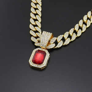 Macro shot of gold hiphop pendant with rectangle red gemstone and micro-pave zircons