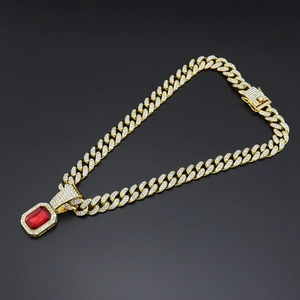 Detail of hip hop gold cuban link necklace with iced out rectangular ruby pendant