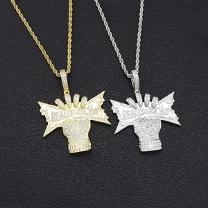 Detail of Really Rich hip hop pendants in gold and silver with full zircon stones