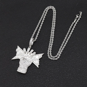 Macro detail of silver hip hop pendant with Really Rich text and micro-set zircons