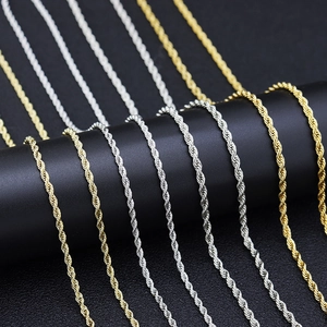 Detailed close-up of 3mm gold and silver stainless steel rope chains on black display